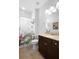 Bathroom featuring granite countertops, dark cabinetry, and a shower with a patterned shower curtain at 1374 Red Clover Ln, Deland, FL 32724