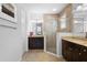 Bathroom featuring dual vanities, tiled floors, and a glass enclosed shower at 1374 Red Clover Ln, Deland, FL 32724