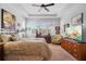 Bedroom featuring a tray ceiling, a ceiling fan, shuttered windows, and furnishings at 1374 Red Clover Ln, Deland, FL 32724