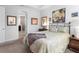 Bedroom with an open doorway to a bathroom featuring a carpeted floor and furniture at 1374 Red Clover Ln, Deland, FL 32724