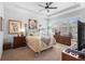 Bedroom featuring a tray ceiling, a ceiling fan, shuttered windows, and furnishings at 1374 Red Clover Ln, Deland, FL 32724