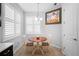 Bright breakfast nook with a small, round table, two chairs, white shutters, and natural light at 1374 Red Clover Ln, Deland, FL 32724