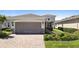 Charming single Gathering home featuring a two car garage, neutral paint, manicured lawn, and lovely landscaping at 1374 Red Clover Ln, Deland, FL 32724