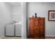 View of a hallway featuring a laundry area with a washer and dryer as well as a decorative cabinet at 1374 Red Clover Ln, Deland, FL 32724