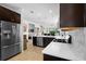Spacious kitchen with granite counters, stainless appliances, mosaic backsplash, and dark wood cabinetry at 1374 Red Clover Ln, Deland, FL 32724