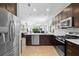 Open kitchen with granite countertops, stainless steel appliances, dark wood cabinetry, and recessed lighting at 1374 Red Clover Ln, Deland, FL 32724