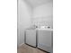 Image of a laundry room featuring a white washer and dryer, as well as a wire shelf at 1374 Red Clover Ln, Deland, FL 32724