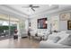 Bright living room with sliding glass doors to lanai, comfortable seating, and contemporary decor at 1374 Red Clover Ln, Deland, FL 32724