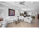 Open-concept living room with tile floors, neutral paint, and large windows providing plenty of natural light at 1374 Red Clover Ln, Deland, FL 32724