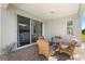Charming covered patio boasts comfortable seating and a view of the lush backyard at 1374 Red Clover Ln, Deland, FL 32724