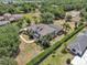 Aerial view showcasing the home's layout, pool, and lush surrounding landscape at 1420 Shady Meadow Ln, Deland, FL 32724