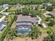 Expansive backyard features a screened pool, mature landscaping, and a private setting, perfect for outdoor living at 1420 Shady Meadow Ln, Deland, FL 32724