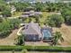 Aerial view of the rear of the property showcasing the pool and privacy landscaping around the home at 1420 Shady Meadow Ln, Deland, FL 32724