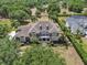 Aerial view of a large home with a well-manicured lawn and mature trees at 1420 Shady Meadow Ln, Deland, FL 32724