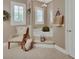 Bathroom features a soaking tub, chandelier lighting, and shuttered windows at 1420 Shady Meadow Ln, Deland, FL 32724