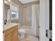 Well-lit bathroom featuring a shower-tub combo, single sink vanity, and neutral finishes at 1420 Shady Meadow Ln, Deland, FL 32724