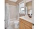 Bright bathroom featuring a shower-tub combo, vanity with sink, and neutral color scheme at 1420 Shady Meadow Ln, Deland, FL 32724