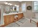 Bathroom boasts a double vanity, linen storage, and neutral-toned tiling at 1420 Shady Meadow Ln, Deland, FL 32724
