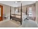 Spacious primary bedroom with a four-poster bed, neutral walls, and lots of natural light at 1420 Shady Meadow Ln, Deland, FL 32724