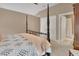 Comfortable primary bedroom featuring a four poster bed and an ensuite bathroom at 1420 Shady Meadow Ln, Deland, FL 32724