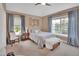 Bright bedroom with blue curtains, carpeted floor, and large windows offering serene outdoor views at 1420 Shady Meadow Ln, Deland, FL 32724