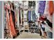 Walk-in closet is well-organized with clothing racks, shelving, and storage bins at 1420 Shady Meadow Ln, Deland, FL 32724