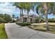 Exterior view showing well-manicured lawn, mature trees, and long driveway leading to attached garage at 1420 Shady Meadow Ln, Deland, FL 32724