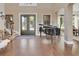 Grand foyer showcasing the front entry door, a black piano, hardwood floors, and staircase; the space combines classic style and elegance at 1420 Shady Meadow Ln, Deland, FL 32724