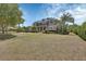 Stately two-story home with stone accents, a balcony, and a beautifully landscaped front yard at 1420 Shady Meadow Ln, Deland, FL 32724