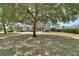 Suburban home with mature trees and a lush front lawn, creating a park-like setting at 1420 Shady Meadow Ln, Deland, FL 32724