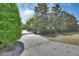 View of the gated entrance to the estate, surrounded by mature trees and landscaping at 1420 Shady Meadow Ln, Deland, FL 32724