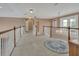 Spacious upstairs hallway with white railings and a view of the home's interior at 1420 Shady Meadow Ln, Deland, FL 32724