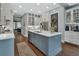 Bright, modern kitchen features a center island, pendant lighting, stainless steel appliances, and seamlessly connects to the dining area at 1420 Shady Meadow Ln, Deland, FL 32724