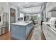 Well-appointed kitchen with island, stainless appliances, custom cabinets and fixtures, hardwood floors, and plenty of natural light at 1420 Shady Meadow Ln, Deland, FL 32724