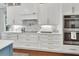 Modern kitchen featuring sleek white cabinetry, stainless steel appliances, stylish backsplash, and quartz countertops at 1420 Shady Meadow Ln, Deland, FL 32724