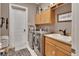 Laundry room with stainless steel washer and dryer and lots of storage space at 1420 Shady Meadow Ln, Deland, FL 32724