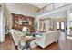 Open-concept living room with hardwood floors, stylish furniture, and a cozy fireplace at 1420 Shady Meadow Ln, Deland, FL 32724