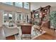 Spacious living room features hardwood floors, a fireplace, and a wall of windows for natural light at 1420 Shady Meadow Ln, Deland, FL 32724