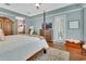 Light-filled main bedroom boasts a four-poster bed, wood floors, and access to a private outdoor space at 1420 Shady Meadow Ln, Deland, FL 32724