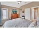 Comfortable main bedroom featuring a large bed, neutral tones, and access to a balcony at 1420 Shady Meadow Ln, Deland, FL 32724