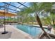 Inviting pool with lush landscaping and a screened enclosure at 1420 Shady Meadow Ln, Deland, FL 32724