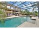 Large screened pool and jacuzzi area with beautiful landscaping around the house at 1420 Shady Meadow Ln, Deland, FL 32724