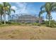 Screened in pool with palm trees and manicured landscaping around the exterior of the home at 1420 Shady Meadow Ln, Deland, FL 32724