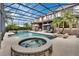 Large screened-in pool area with jacuzzi, palm trees, and lounge seating at 1420 Shady Meadow Ln, Deland, FL 32724