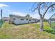 A spacious backyard with a chainlink fence and mature trees offers privacy at 150 Reef Rd, South Daytona, FL 32119