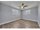 Bedroom with light blue walls, wood-look floors, and dual windows at 150 Reef Rd, South Daytona, FL 32119