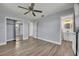 Bedroom with wood-look flooring, ceiling fan, and en-suite bathroom at 150 Reef Rd, South Daytona, FL 32119