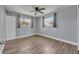 Bedroom featuring light blue walls, wood-look floors, and a ceiling fan at 150 Reef Rd, South Daytona, FL 32119