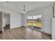 Open dining room with wood-look floors and sliding glass door to the patio at 150 Reef Rd, South Daytona, FL 32119
