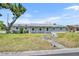 Charming single-story home with a well-maintained lawn, front yard tree, and a welcoming walkway at 150 Reef Rd, South Daytona, FL 32119